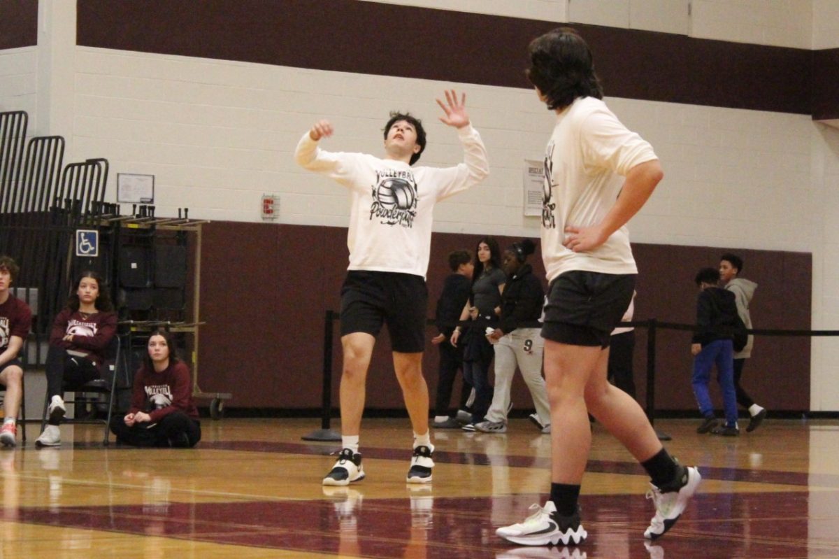 Aidan Brier, '26, serves the ball.