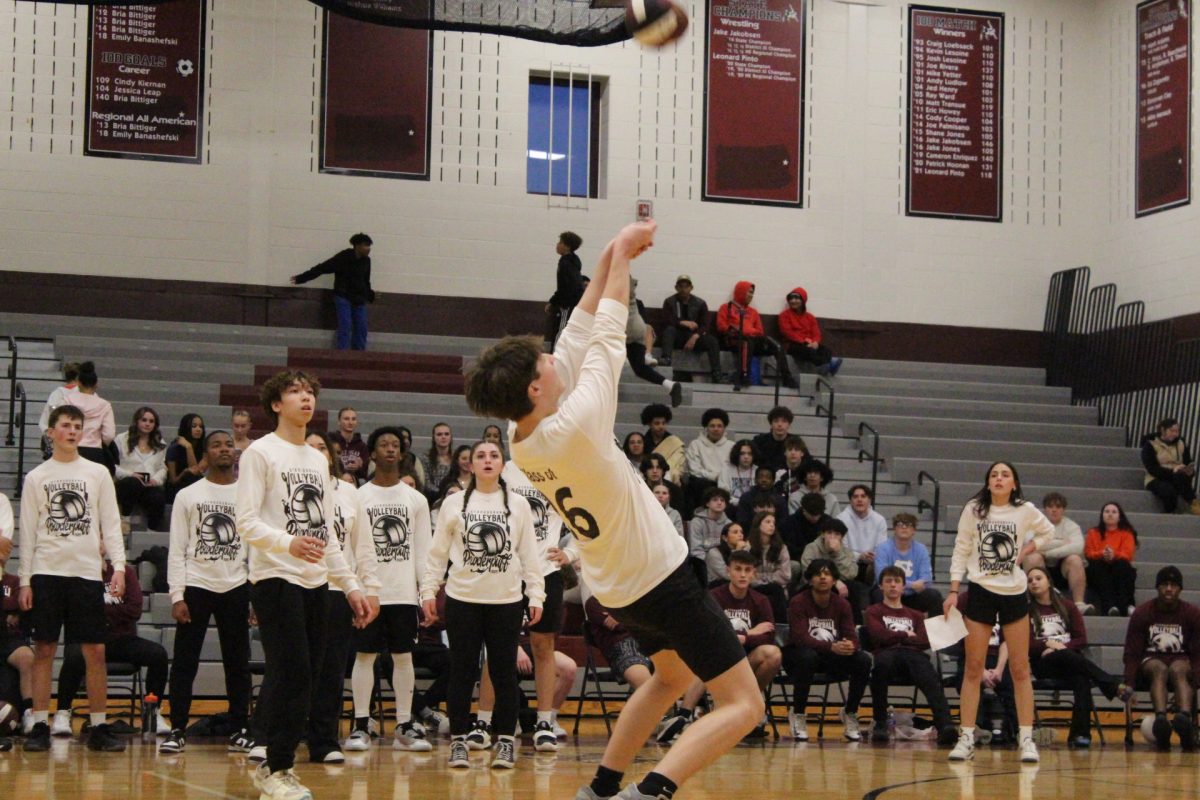 Alvino Trifilo, '26, bumps the ball over the net. 