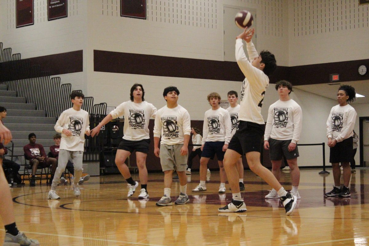 Aidan Brier, '26, sets the ball.