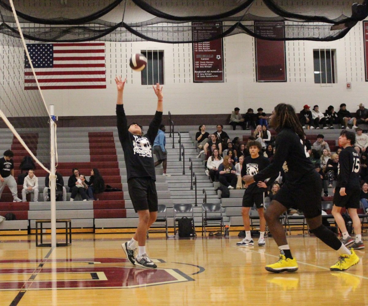 Matthew Sanchez, '25, sets the ball.