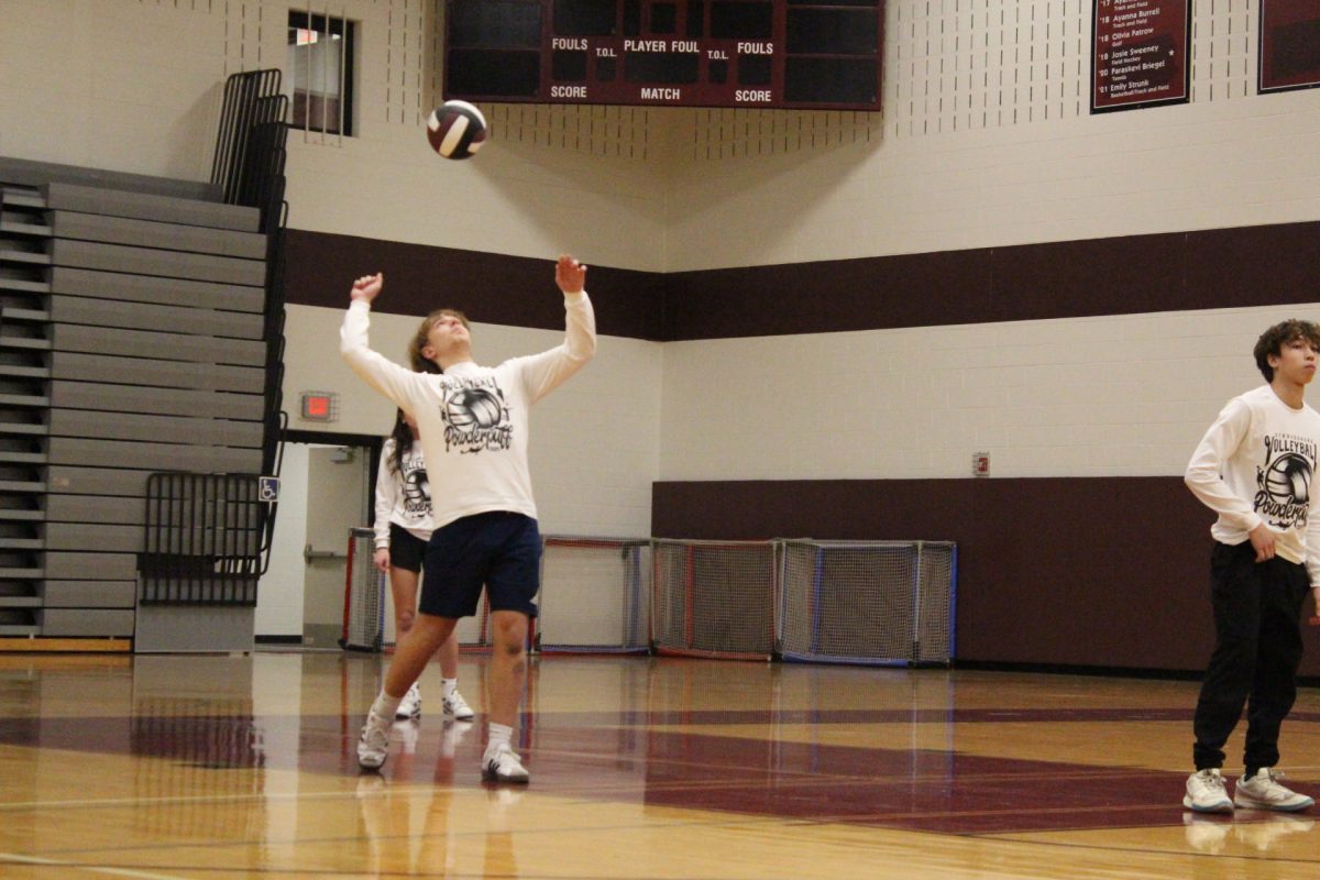 A member of the junior class team serves.