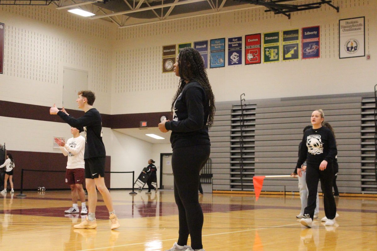 The senior class managers watch the game.