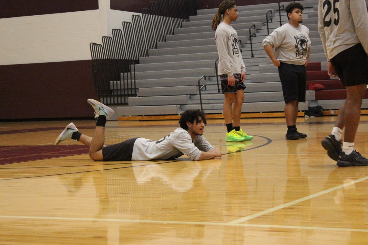 Essam Alrefai, '26, lays on the ground as he waits for the referees to decide on a point.