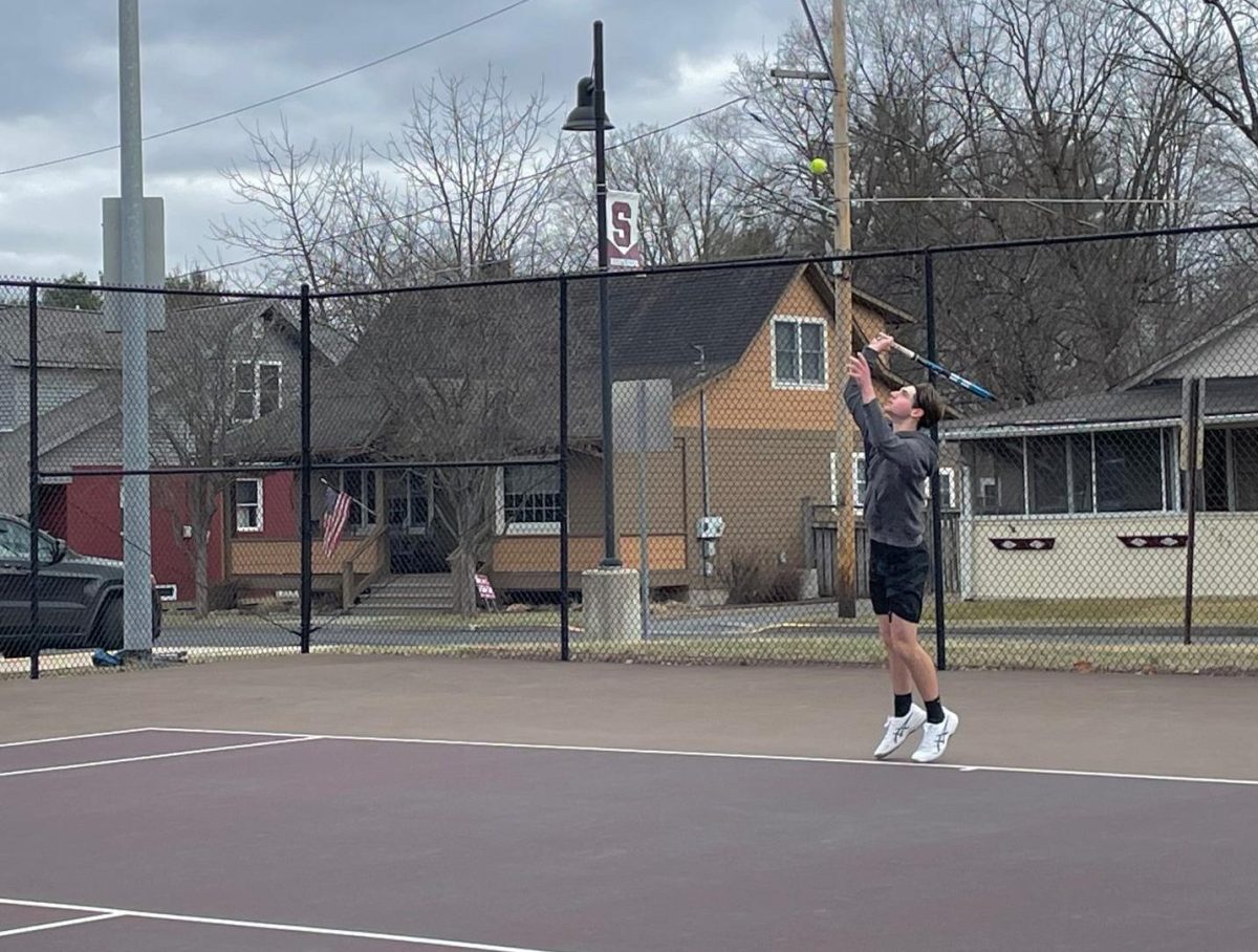 Logan Casebolt, '25, preparing to serve the ball in his Whitehall High School match.