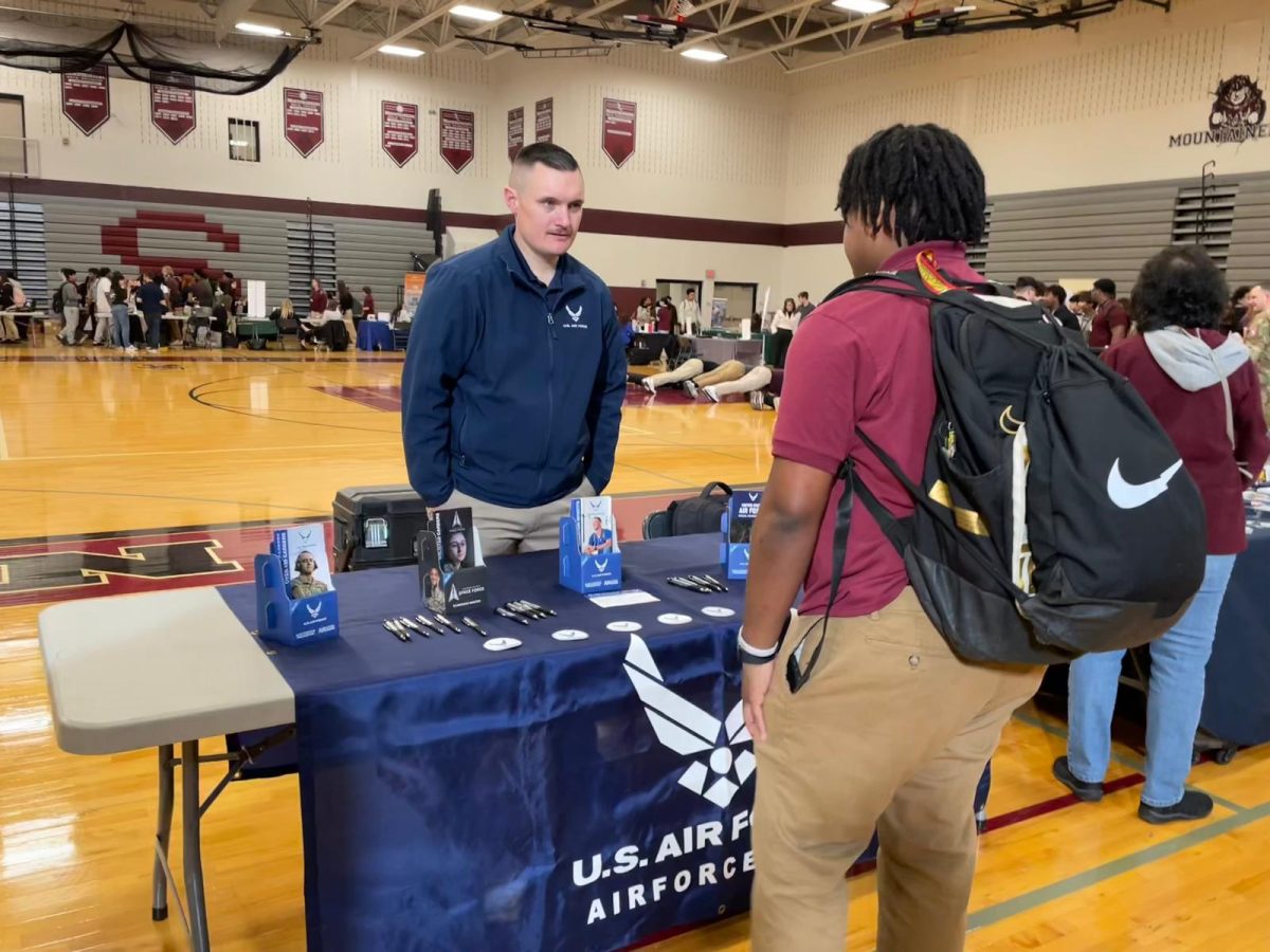 Nhyle Barron, ’27, checking out the US Army Air Force booth and speaking with their representative.