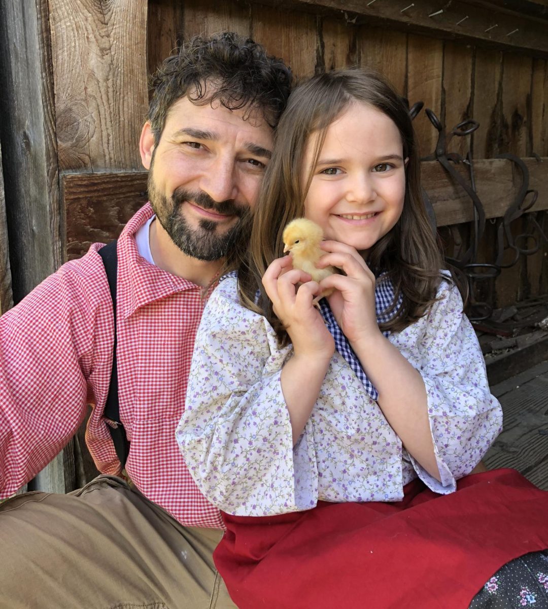 Father and daughter at the Quiet Valley Farm Animal Frolic from a previous year holding a chick. Photo provided by Quiet Valley Farm and used with permission. 