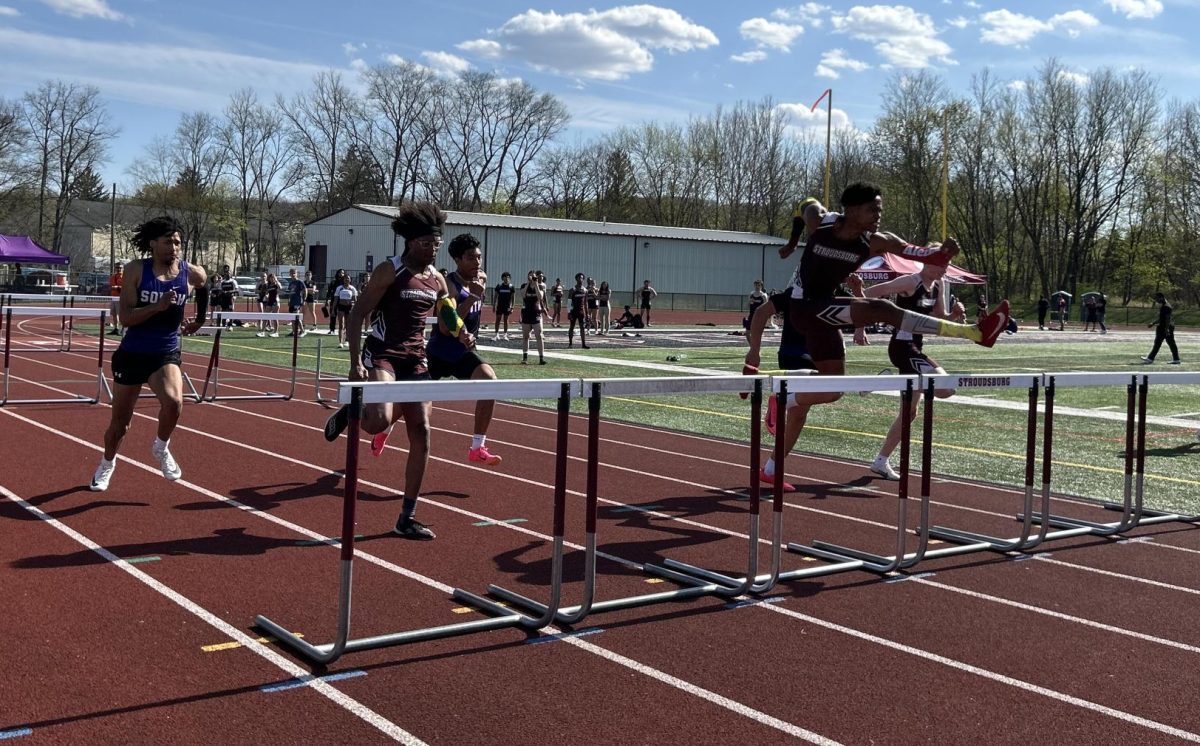 Darrien Burke, '25, Abiel Quartey, '25, Aidan Coyne, '25, fighting for first place in the their 110m hurdles race against East Stroudsburg South.