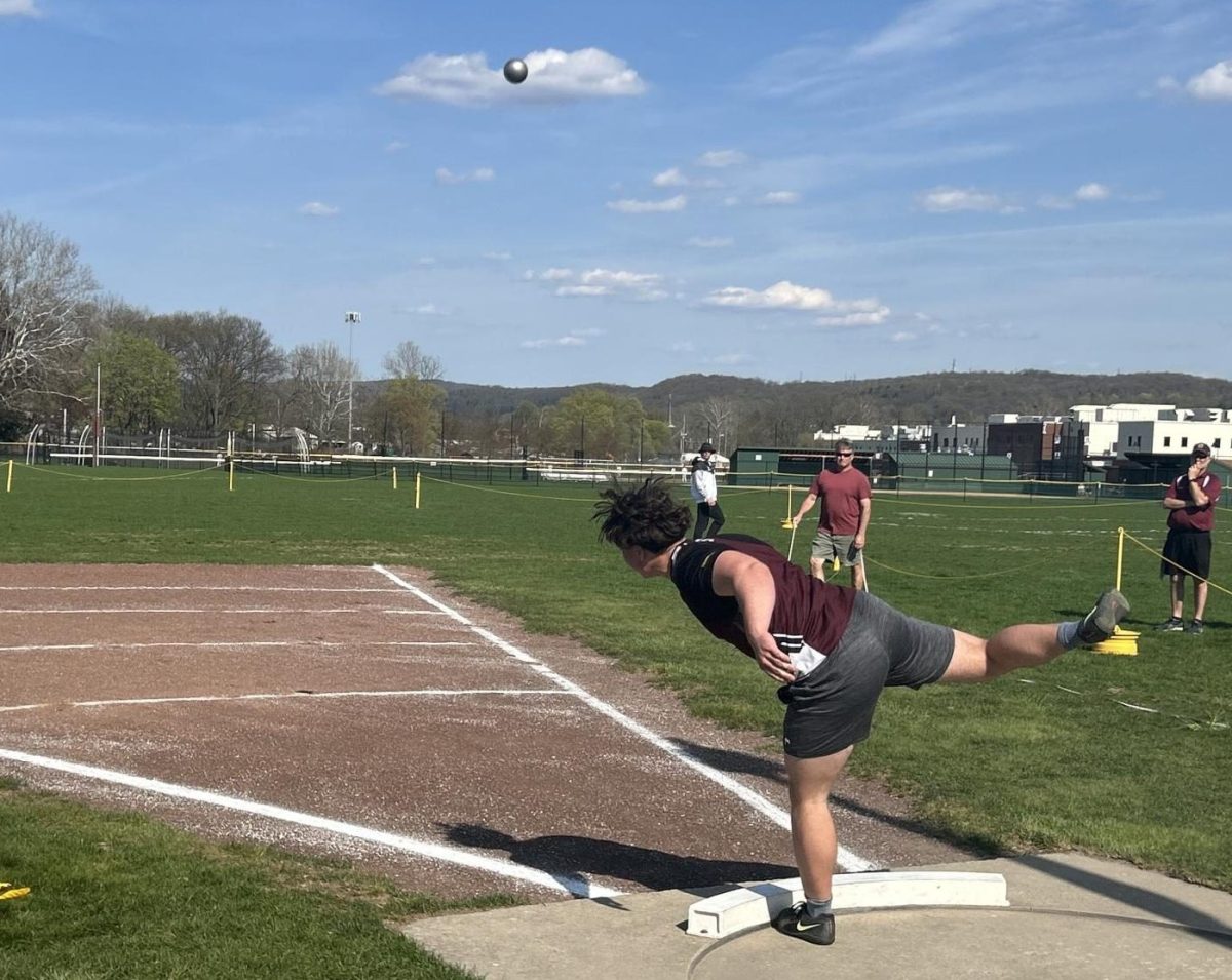 Octavian Riszko, '26, competing in shotput against the Cavaliers. 