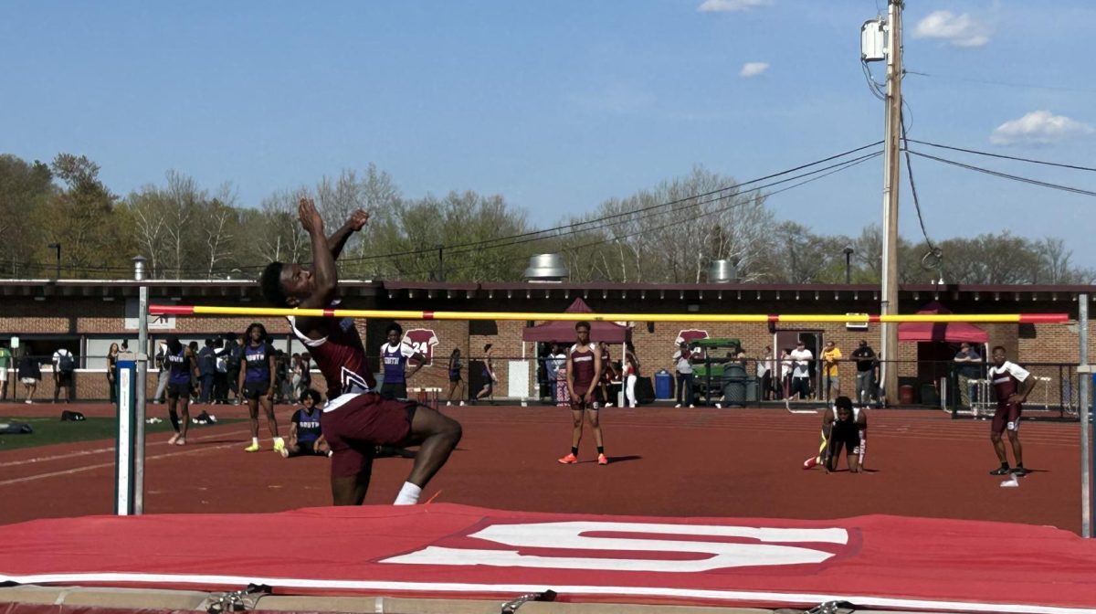 Kameron Knight, '26, running up to jump over the bar in his high jump event against East Stroudsburg South.