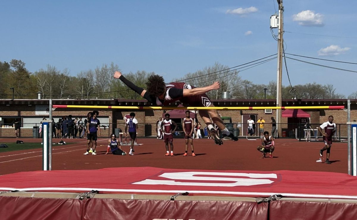 Ethan Dudsak, '25, jumping over the bar in his high jump event against East Stroudsburg South.