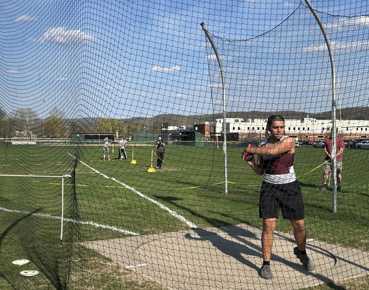 Armani Crespo, '25, warming up to toss his discus against East Stroudsburg South.