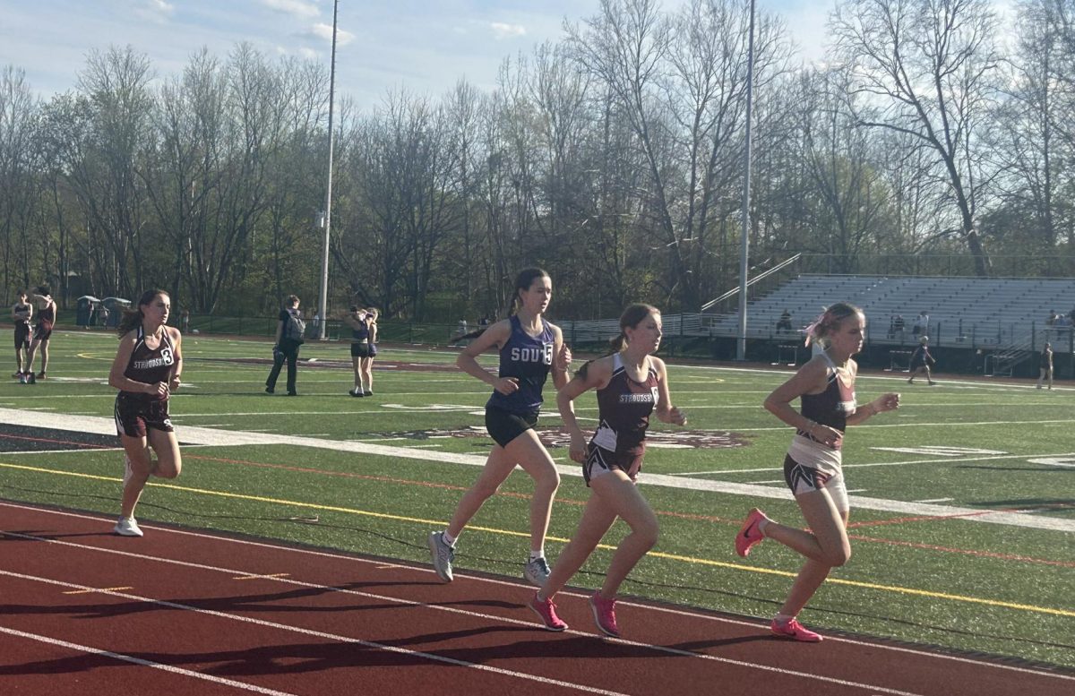 Catharine Brinker, '25, Carolyn Roberti, '25, and Anaya Hein, '28, compete in the mile against East Stroudsburg South.


