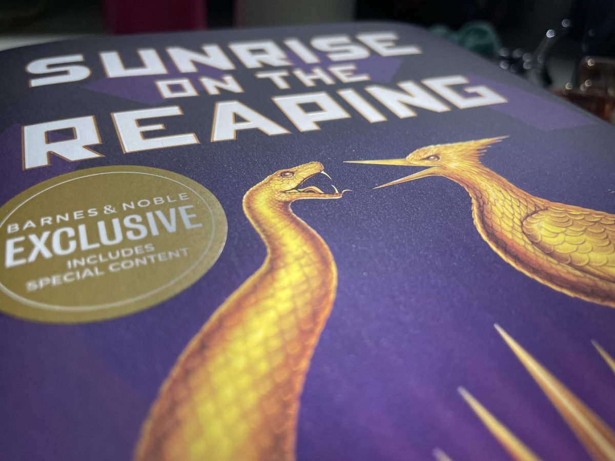 The cover of "Sunrise on the Reaping" zoomed in to the title and the golden animals. 
