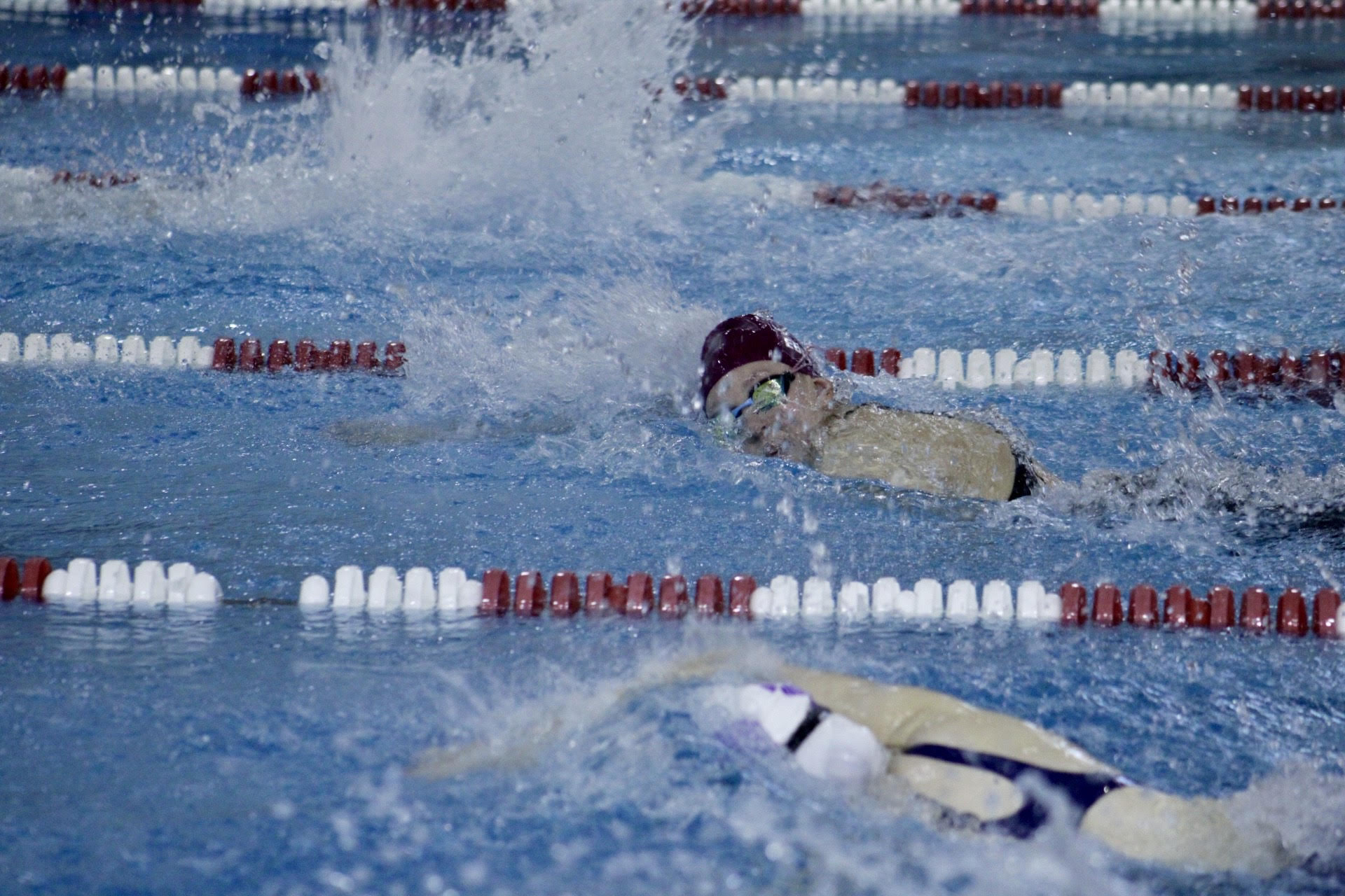 Anna Kirby competing during a swim meet during the 2024-25 season