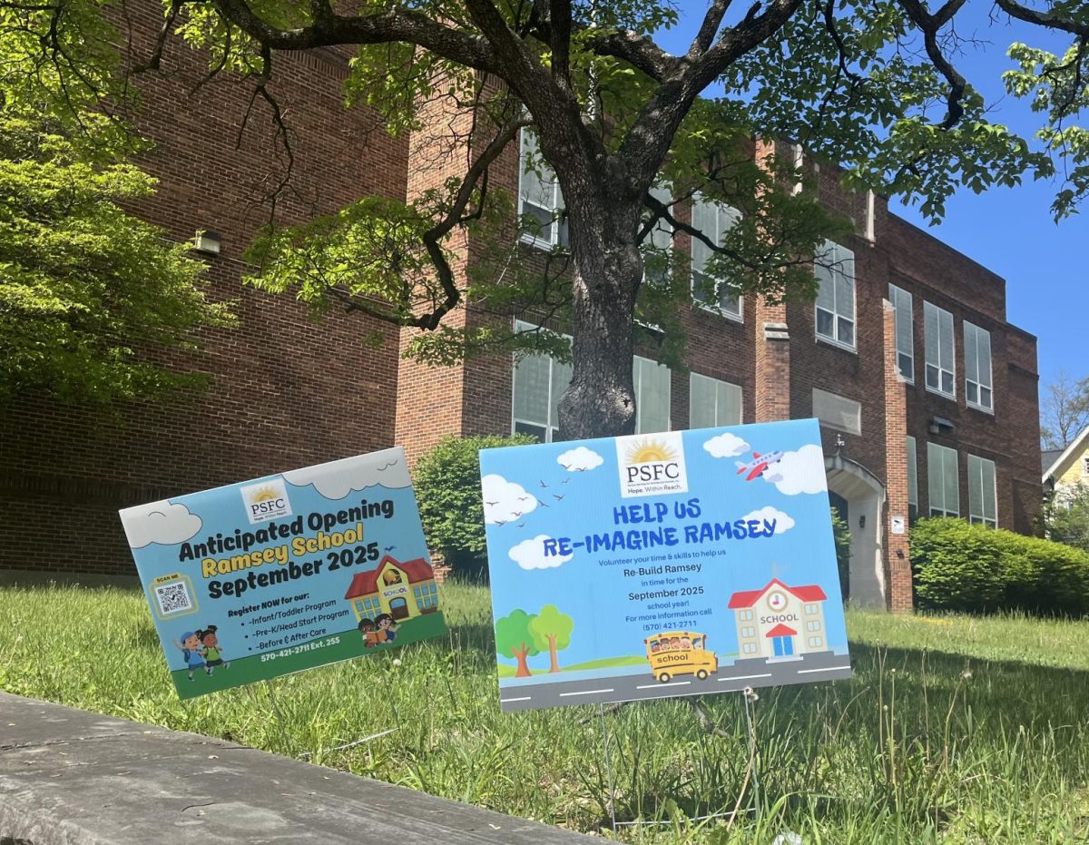 Signs outside Ramsey school showing when and what Ramsey will be used for when it re-opens.