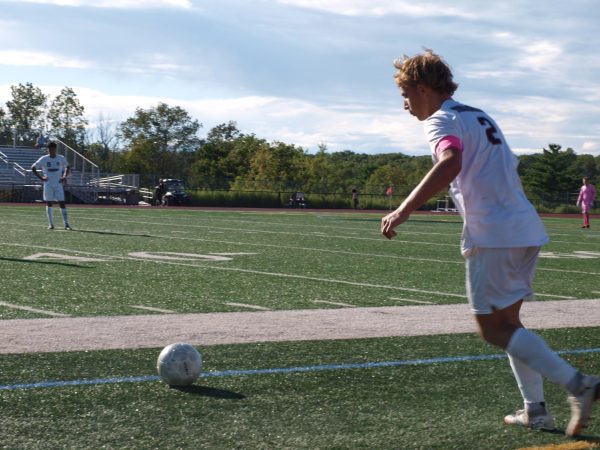 Varsity captain Kaidhn Schatzman, '26 approaching the ball for a long pass.