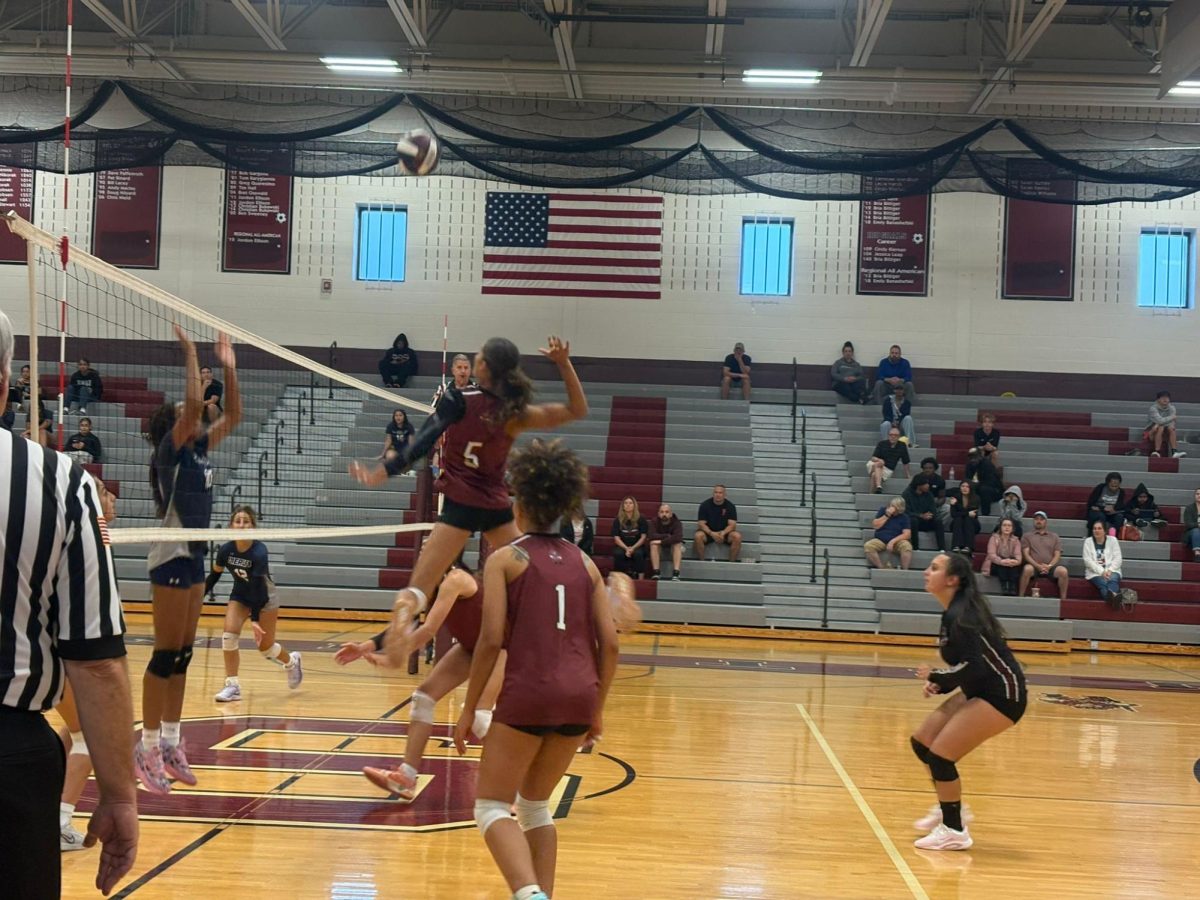 Madelyn Vargas, '27, spiking the ball like a professional in the game against Dieruff High School.