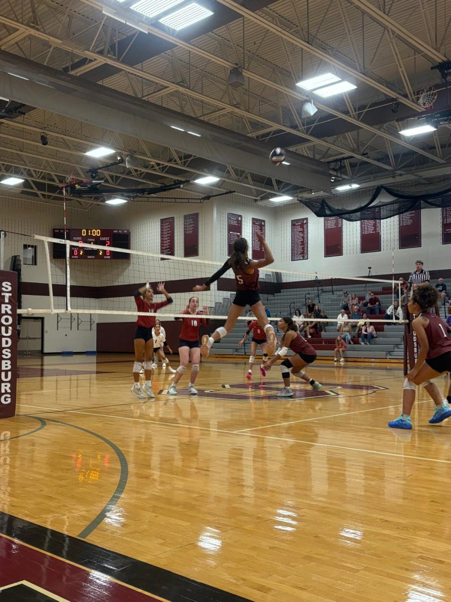Madelyn Vargas, '27, jumps to spike the ball during the Liberty game.