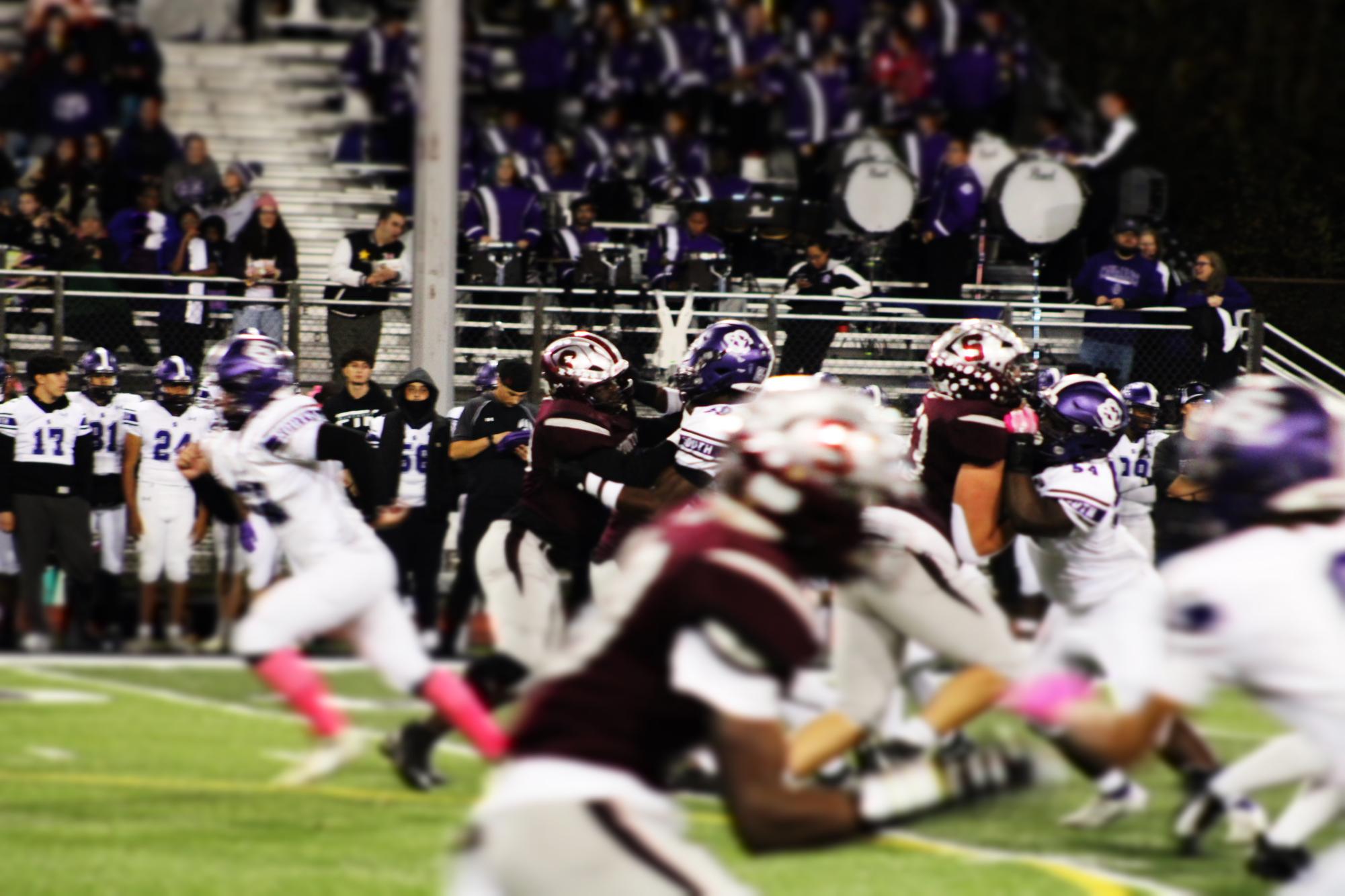 A Mountie and a Cavalier fight off each other for the Mounties to take the ball to the end zone.
