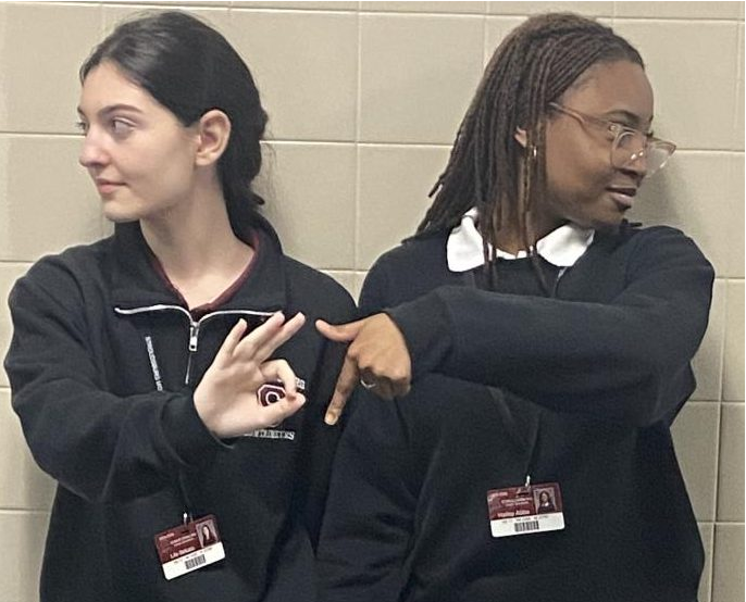 Lile Bekaia, 27', and Hailey Abba, 27', holding up 6'7 while leaning against the wall.