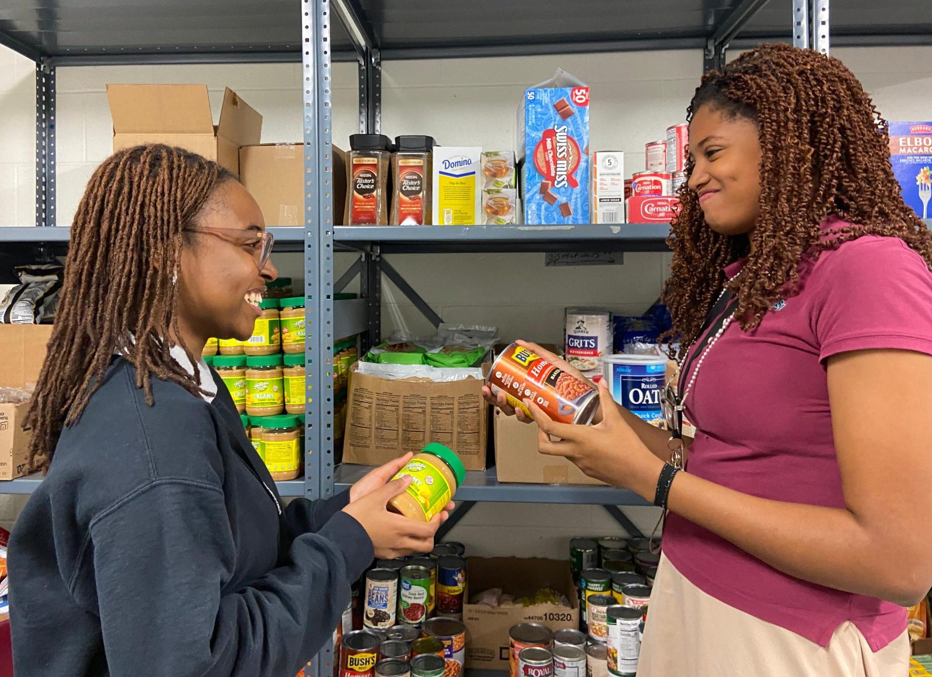 FBLA members having a good time as they restock the shelves in the food pantry.