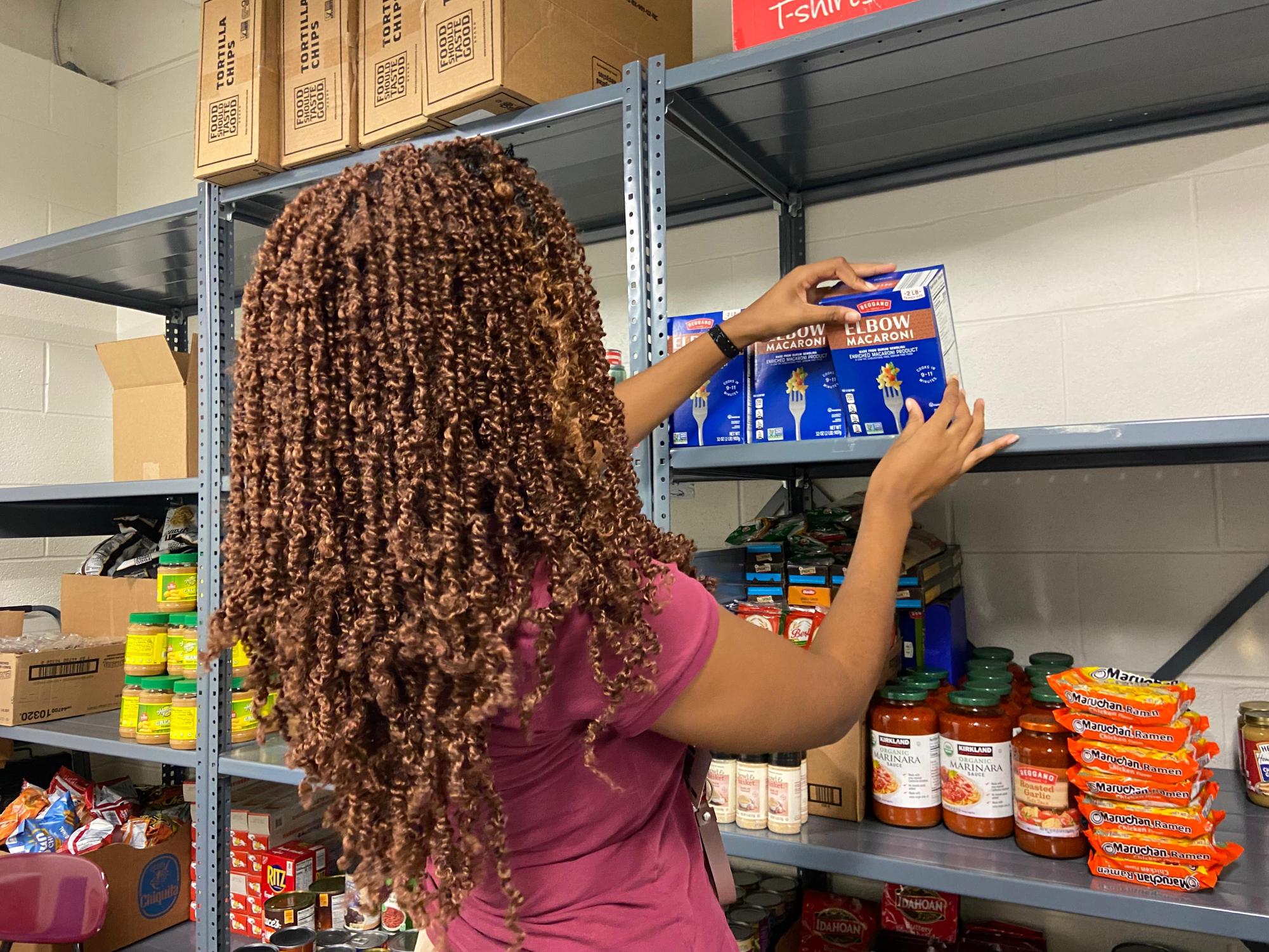 Karen Chapman, an FBLA member, stocking the main shelves in the food pantry.