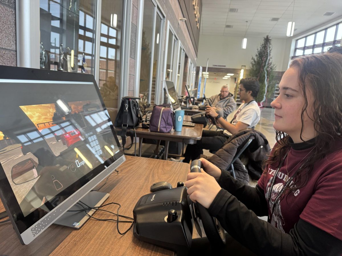Katren Lavra, '26, plays the Distracted Driving Simulator.