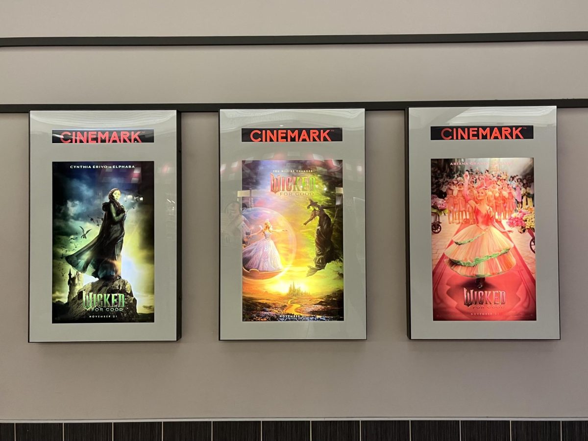 Three promotional "Wicked; For good" posters at Cinemark in the mall.