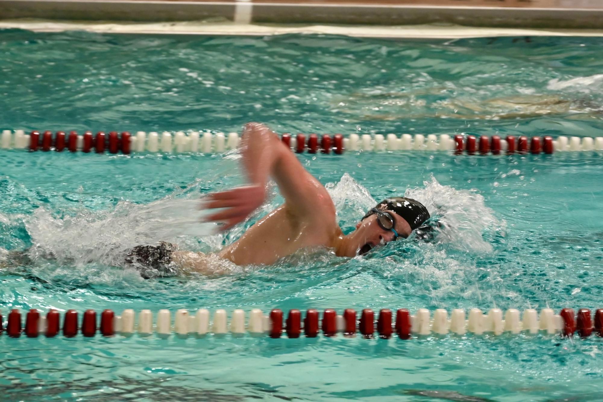 Kacper Soja, '29, swimming fast laps of freestyle in a home meet. 
