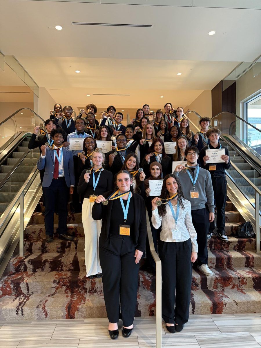 FBLA RLC 21 qualifiers holding their medals and certificate as they stand for a group photo. Photo taken by FBLA advisors.