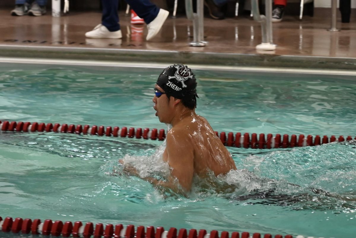Alfred Zheng, '26, competing in breaststroke, out-swimming all his opponents.