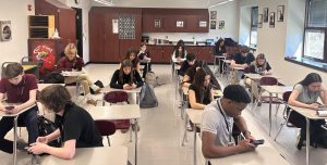 Students in Journalism 1 not using their phones effectively and for educational purposes during class. (Staged photo)