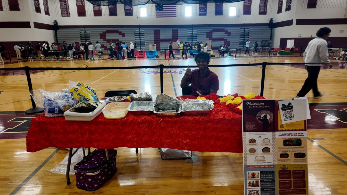 Davin Humphrey, '27 posing with the Hinduism booth.