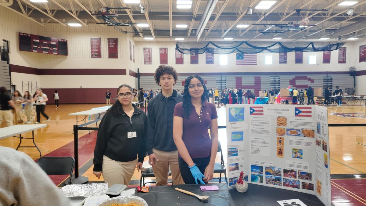 Picture of Puerto Rican booth at diversity fair with Amber Calllaro, '27, Teyson Rosado, '27, and Kayla Centeno, '27.
